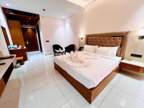 a bedroom with a large bed in a room at The Velvista Hotel in Muzaffarnagar