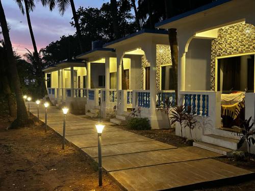 a row of lights in front of a house at night at La Serene Inn in Arambol