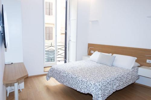 a bedroom with a bed and a large window at Stay In Rome in Rome