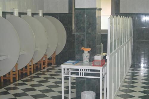 a row of white plates in a room with a table at Hotel Balneario De Alceda in Alceda