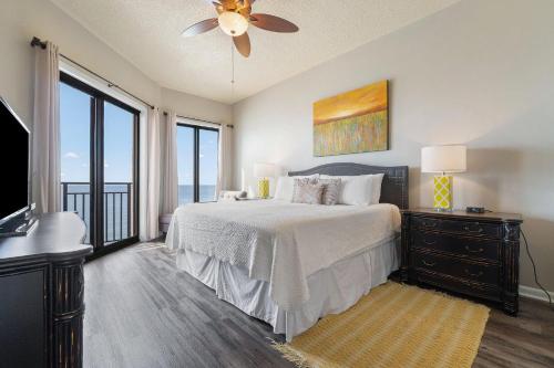 a bedroom with a bed and a ceiling fan at Seachase 1503W in Orange Beach