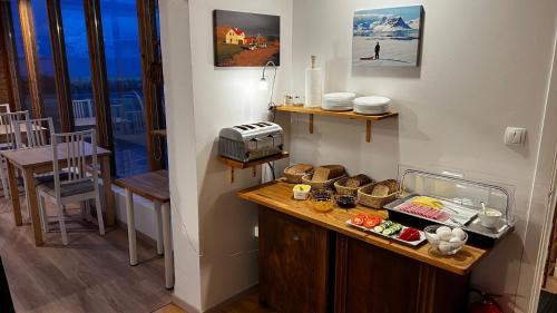 a kitchen with a counter with food on it at Sudur-Bár Guesthouse in Grundarfjordur