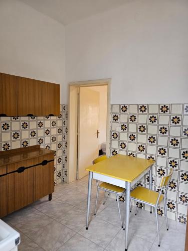 una cucina con tavolo e sedie in una stanza di Residence Arlecchino a Lido Conchiglia