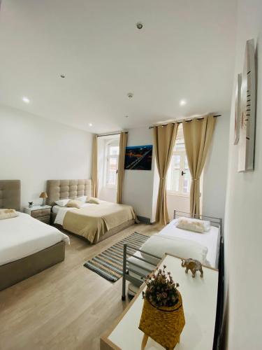 a hotel room with two beds and a table at Douro sunset lounge in Porto