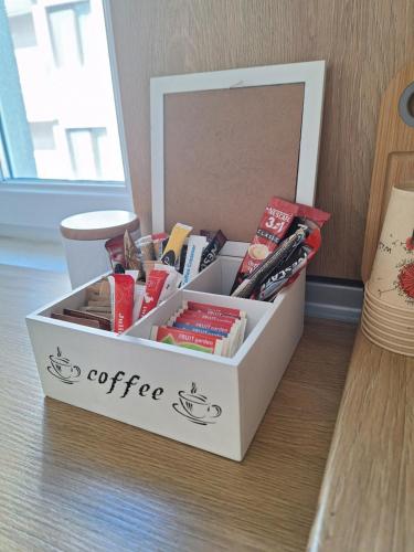 a white coffee box sitting on the floor next to a mirror at Danaya in Petrich
