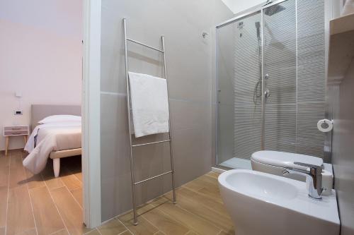 a bathroom with a shower and a toilet and a sink at Musto Suites & Rooms in Naples