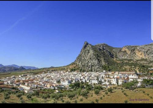a small town in front of a mountain at Casa Rosa1 in Valle de Abdalagís
