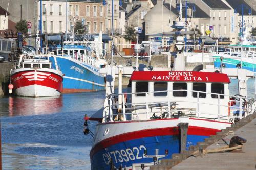 a boat is docked at a dock with other boats at Les Tourelles Village de vacances in Asnelles