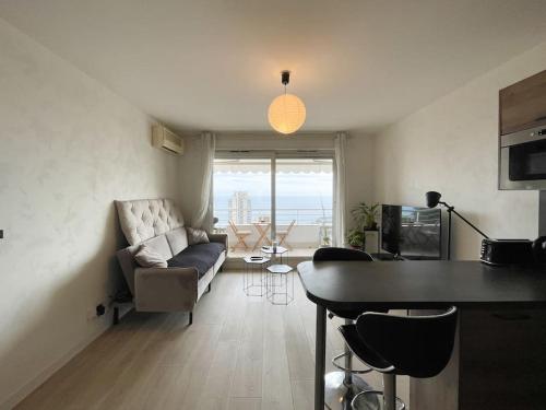 a living room with a couch and a table at Monte carlo vista in Beausoleil