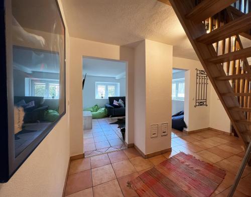 a hallway with a living room and a staircase at Haus am Berzdorfer See in Görlitz