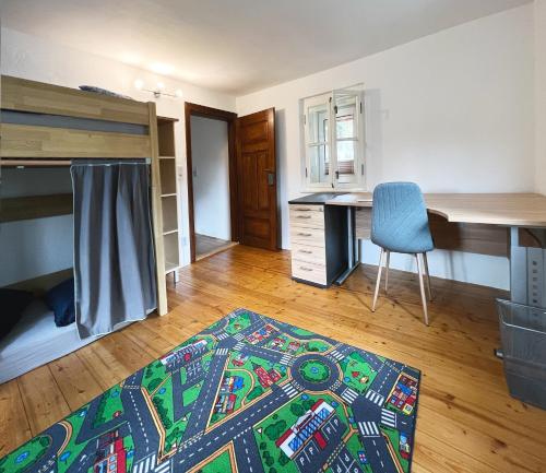 a bedroom with a bed and a desk and a chair at Haus am Berzdorfer See in Görlitz