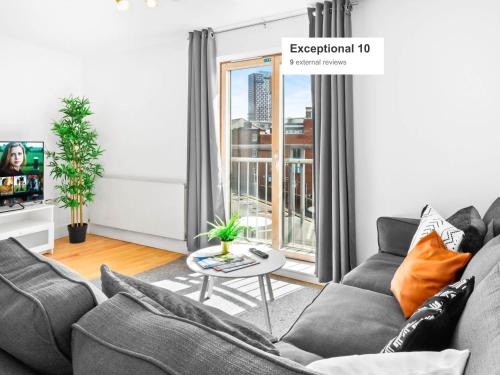 a living room with a couch and a table at City Centre - Two Bedroom Apartment - Juliet Balcony - Secure Parking - WIFI - Smart TV - Top Rated -33S in Birmingham