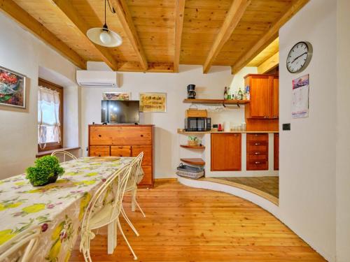 a kitchen and dining room with a long table at Welcome Traveller BERNARDO HOUSE in Garda