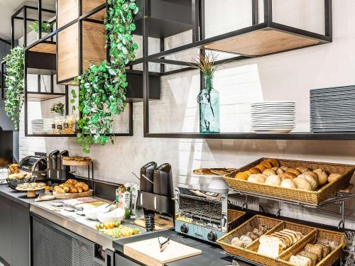 a kitchen with bread and other food on a counter at Hotel ibis Bragança in Bragança