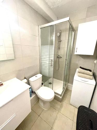 une salle de bain avec toilettes et douche en verre dans l'établissement Appart CLIM , WIFI, PLAGE 200 mètres, à Argelès-sur-Mer