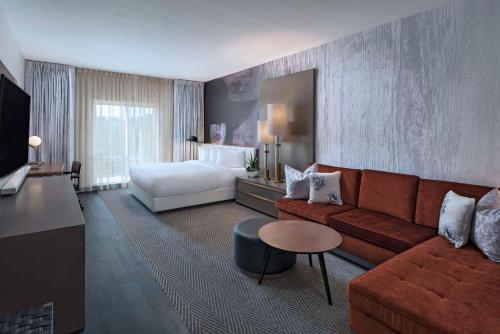 a hotel room with a couch and a bed at Hyatt Centric The Woodlands in The Woodlands