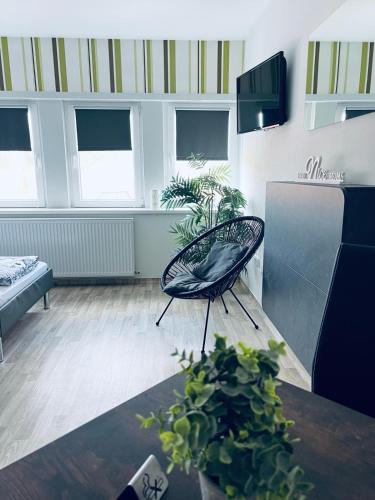 a living room with a chair and a table at Hotel Stadt Boizenburg in Boizenburg