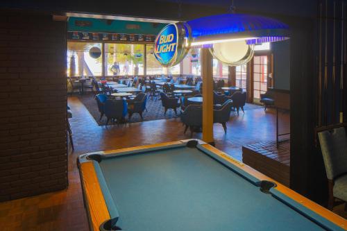 a pool table in a room with a restaurant at San Simeon Lodge in San Simeon