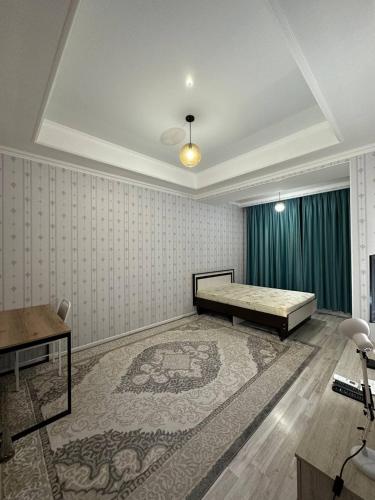 a bedroom with a bed and a rug at 1-room apartment Masaka in Bishkek