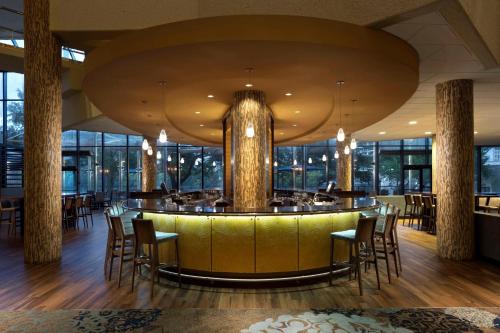 a restaurant with a bar with chairs and a large ceiling at Hyatt Regency Austin in Austin