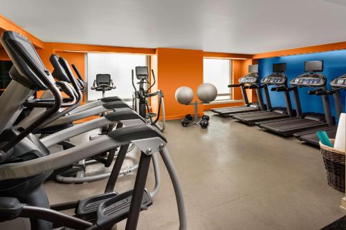 a gym with several tread machines in a room at Hyatt Centric Arlington in Arlington