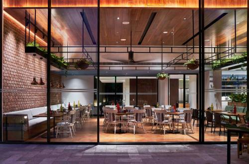 a restaurant with tables and chairs in a building at Hyatt Centric MG Road Bangalore in Bengaluru