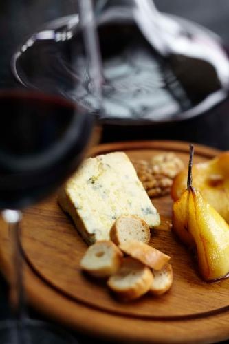 a plate of cheese and fruit on a table at Park Hyatt Hotel and Residences, Hyderabad in Hyderabad