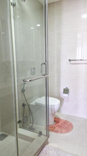 a bathroom with a toilet and a glass shower at The Fortress in Sri Jayewardenepura Kotte