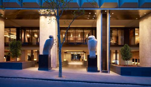 two statues of birds are in the middle of a building at Grand Hyatt Melbourne in Melbourne