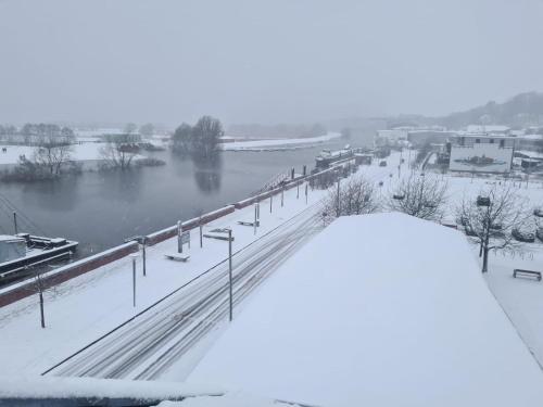 a view of a river with snow on the ground at Hotel Stadt Boizenburg in Boizenburg