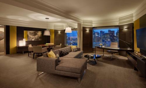 a living room with a couch and a dining room at Grand Hyatt Melbourne in Melbourne