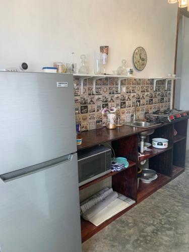 a kitchen with a refrigerator and a counter at Villa Noblezza in Las Lagunas