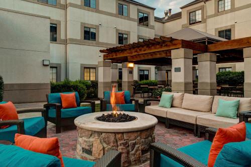 a patio with a fire pit in front of a building at Hyatt House Boston/Burlington in Burlington