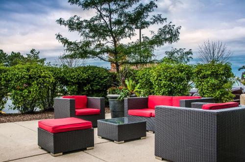 a group of chairs and tables on a sidewalk at Hyatt House Chicago Schaumburg in Schaumburg