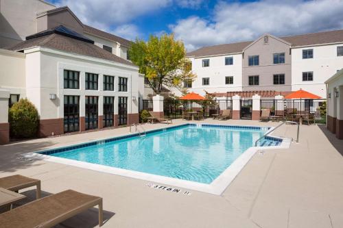 a swimming pool in front of a building at Hyatt House Boston Waltham in Waltham