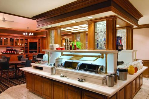 a kitchen with a large island with a stove at Hyatt House Dallas Addison in Addison