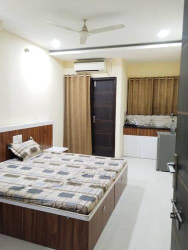 a bedroom with a large bed in a room at Park facing flat for yr comfort in Indore