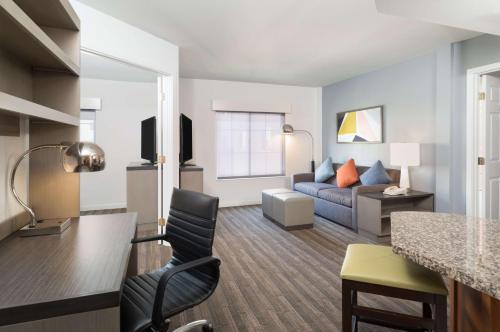 a living room with a couch and a table at Hyatt House White Plains in White Plains
