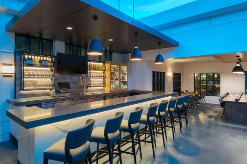 a bar with a row of blue stools at Hyatt House White Plains in White Plains