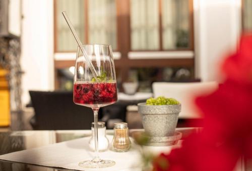 a glass of wine sitting on top of a table at Hotel Gasthof Zur Post in Königstein in der Oberpfalz