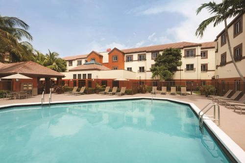 a large swimming pool in front of a building at Hyatt House Miami Airport in Miami