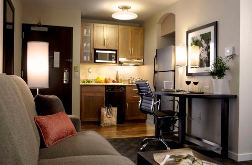 a living room with a couch and a kitchen at Hyatt House Philadelphia-King of Prussia in King of Prussia