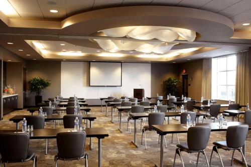 a conference room with tables and chairs and a podium at Hyatt House Philadelphia-King of Prussia in King of Prussia