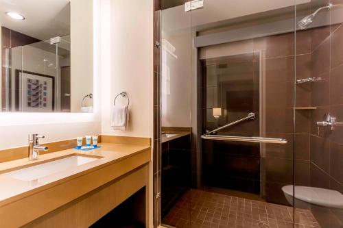 a bathroom with a sink and a shower at Hyatt House Salt Lake City Downtown in Salt Lake City