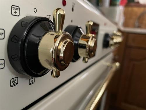 a close up of three knobs on an oven at Villa Olga & studios in Mola Kalyva