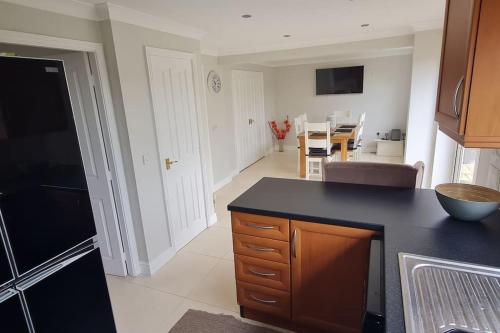 a kitchen with a black counter top in a room at Four bed detached home in Nottingham in Nottingham