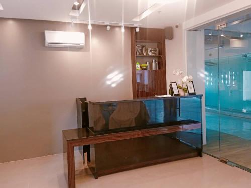 a glass display case in a room with a pool at Soleil Suites Cebu in Cebu City