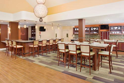 a large dining room with a large table and chairs at Hyatt House Belmont Redwood Shores in Belmont