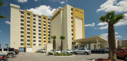 a large hotel with cars parked in a parking lot at Hyatt Place Daytona Beach-Oceanfront in Daytona Beach