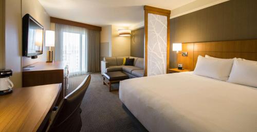 a hotel room with a bed and a chair at Hyatt Place Daytona Beach-Oceanfront in Daytona Beach